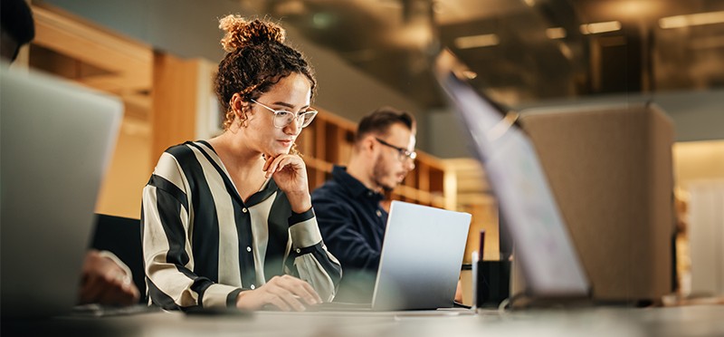 Woman sitting and working at a laptop